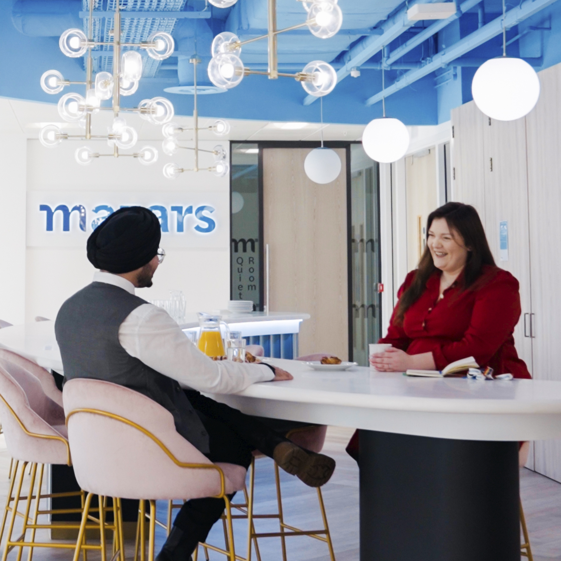 Mazars employees chatting around table 